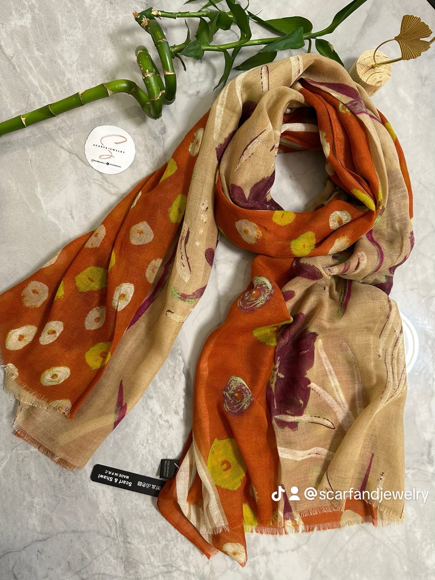 Colorful scarf with floral pattern on a textured surface